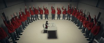 Movie still from “Hypnotic” (2023), directed by Robert Rodriguez – A group of people standing in front of a table; Extreme Wide shot, High angle