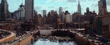 Movie still from “I Am Legend” (2007), directed by Francis Lawrence – A view of a large city from a bridge over a river; Extreme Wide shot, High angle
