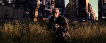 Movie still from “I Am Legend” (2007), directed by Francis Lawrence – A man holding a camera while standing in the grass; Wide shot, Low angle