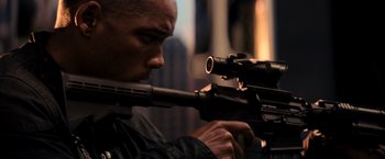 Movie still from “I Am Legend” (2007), directed by Francis Lawrence – A person holding a rifle; Close Up shot, High angle