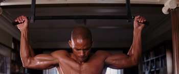 Movie still from “I Am Legend” (2007), directed by Francis Lawrence – A man with his arms stretched out in a room; Medium shot, Low angle