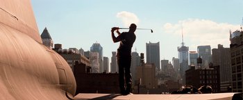 Movie still from “I Am Legend” (2007), directed by Francis Lawrence – A man is playing golf on the roof of a skyscraper; Wide shot, Low angle