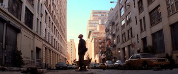 Movie still from “I Am Legend” (2007), directed by Francis Lawrence – A man and a dog walking down a street; Wide shot, Low angle