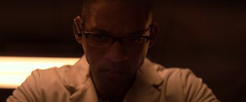 Movie still from “I Am Legend” (2007), directed by Francis Lawrence – A person wearing glasses and a white shirt; Close Up shot, Low angle