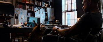 Movie still from “I Am Legend” (2007), directed by Francis Lawrence – A man and a dog sitting on a couch in a living room; Medium shot, Over the shoulder angle