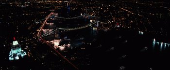 Movie still from “I Am Legend” (2007), directed by Francis Lawrence – An aerial view of a bridge lit up at night; Extreme Wide shot, Overhead angle