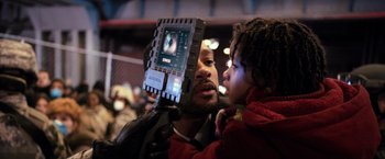 Movie still from “I Am Legend” (2007), directed by Francis Lawrence – A man and a little girl with a computer on their face; Close Up shot, Low angle