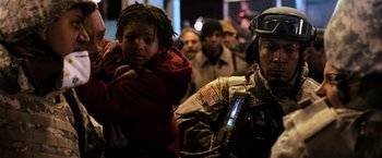Movie still from “I Am Legend” (2007), directed by Francis Lawrence – A group of people standing next to each other on a street; Medium shot, Low angle