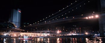 Movie still from “I Am Legend” (2007), directed by Francis Lawrence – A bridge that is lit up at night time; Extreme Wide shot, High angle
