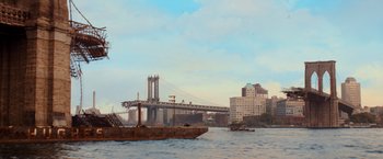 Movie still from “I Am Legend” (2007), directed by Francis Lawrence – A boat floating on a body of water next to a bridge; Extreme Wide shot, Low angle