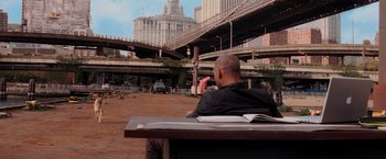 Movie still from “I Am Legend” (2007), directed by Francis Lawrence – A man sitting on a bench in the middle of a city; Wide shot, Over the shoulder angle