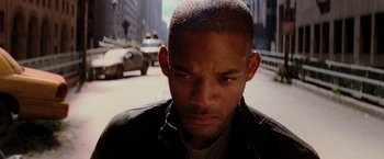 Movie still from “I Am Legend” (2007), directed by Francis Lawrence – A person wearing a jacket on the street; Close Up shot, High angle