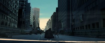 Movie still from “I Am Legend” (2007), directed by Francis Lawrence – A man sitting on the side of a road with a dog; Extreme Wide shot, High angle