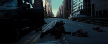 Movie still from “I Am Legend” (2007), directed by Francis Lawrence – A man laying on the ground in the middle of the street; Wide shot, High angle