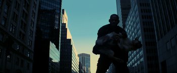 Movie still from “I Am Legend” (2007), directed by Francis Lawrence – A man walking down the street with a dog in his arms; Extreme Wide shot, Low angle