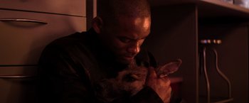 Movie still from “I Am Legend” (2007), directed by Francis Lawrence – A man is holding a cat in his arms; Close Up shot, High angle