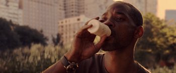 Movie still from “I Am Legend” (2007), directed by Francis Lawrence – A person drinking from a cup; Close Up shot, Low angle