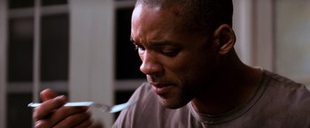 Movie still from “I Am Legend” (2007), directed by Francis Lawrence – A person holding a spoon; Close Up shot, High angle