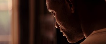 Movie still from “I Am Legend” (2007), directed by Francis Lawrence – A man's face in the dark; Extreme Close Up shot, Low angle