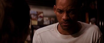 Movie still from “I Am Legend” (2007), directed by Francis Lawrence – A person wearing a white t - shirt; Close Up shot, Over the shoulder angle
