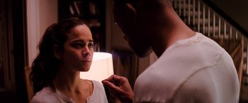 Movie still from “I Am Legend” (2007), directed by Francis Lawrence – A man putting lipstick on a woman's face; Close Up shot, Over the shoulder angle