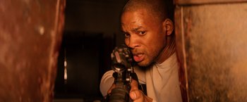 Movie still from “I Am Legend” (2007), directed by Francis Lawrence – A person holding a gun; Close Up shot, High angle