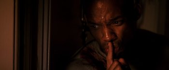Movie still from “I Am Legend” (2007), directed by Francis Lawrence – A person holding his finger to his lips; Close Up shot, High angle