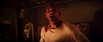 Movie still from “I Am Legend” (2007), directed by Francis Lawrence – A person with blood on his face; Close Up shot, High angle