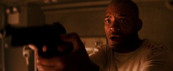 Movie still from “I Am Legend” (2007), directed by Francis Lawrence – A person holding a remote control; Close Up shot, Low angle