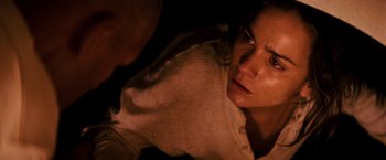 Movie still from “I Am Legend” (2007), directed by Francis Lawrence – A woman's face as a man looks on; Close Up shot, High angle