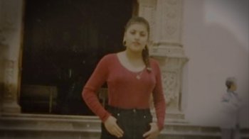 Movie still from “I Am Vanessa Guillen” (2022), directed by Christy Wegener – A young woman standing in front of an ornate building; Medium shot, High angle