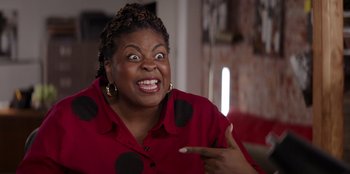 Movie still from “I Believe in Santa” (2022), directed by Alex Ranarivelo – An image of a woman making a funny face; Close Up shot, High angle