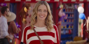 Movie still from “I Believe in Santa” (2022), directed by Alex Ranarivelo – A beautiful young lady with blonde hair and blue eyes wearing a striped sweater; Close Up shot, Over the shoulder angle