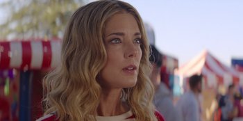 Movie still from “I Believe in Santa” (2022), directed by Alex Ranarivelo – A person with long blonde hair; Close Up shot, Low angle