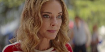 Movie still from “I Believe in Santa” (2022), directed by Alex Ranarivelo – A woman's face with long blonde hair; Close Up shot, Over the shoulder angle