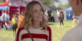 Movie still from “I Believe in Santa” (2022), directed by Alex Ranarivelo – A beautiful young lady wearing a red and white striped sweater; Close Up shot, Over the shoulder angle