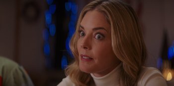 Movie still from “I Believe in Santa” (2022), directed by Alex Ranarivelo – A person with long blonde hair; Close Up shot, Over the shoulder angle