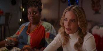 Movie still from “I Believe in Santa” (2022), directed by Alex Ranarivelo – Two women sitting in front of each other in a room; Close Up shot, Over the shoulder angle