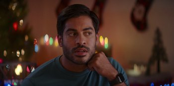 Movie still from “I Believe in Santa” (2022), directed by Alex Ranarivelo – A person wearing a watch; Close Up shot, Over the shoulder angle