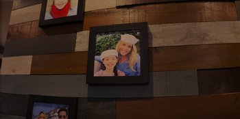 Movie still from “I Believe in Santa” (2022), directed by Alex Ranarivelo – A picture of a woman and a girl in a sailor's hat; Extreme Close Up shot, High angle