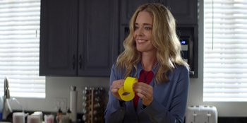 Movie still from “I Believe in Santa” (2022), directed by Alex Ranarivelo – A woman holding a roll of yellow duct tape; Close Up shot, Over the shoulder angle