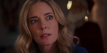 Movie still from “I Believe in Santa” (2022), directed by Alex Ranarivelo – A woman's face looking at the camera; Close Up shot, Over the shoulder angle