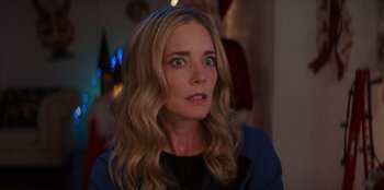 Movie still from “I Believe in Santa” (2022), directed by Alex Ranarivelo – A person with long blonde hair; Close Up shot, Over the shoulder angle