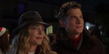 Movie still from “I Believe in Santa” (2022), directed by Alex Ranarivelo – A man and a woman sitting next to each other; Close Up shot, Over the shoulder angle