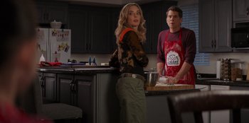 Movie still from “I Believe in Santa” (2022), directed by Alex Ranarivelo – A woman standing next to a man in a kitchen; Medium shot, Over the shoulder angle