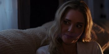 Movie still from “I Believe in Santa” (2022), directed by Alex Ranarivelo – A person sitting on a couch; Close Up shot, Over the shoulder angle