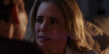 Movie still from “I Believe in Santa” (2022), directed by Alex Ranarivelo – A woman's face in the dark; Close Up shot, Over the shoulder angle