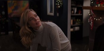 Movie still from “I Believe in Santa” (2022), directed by Alex Ranarivelo – A woman in a white shirt leaning on the ground; Close Up shot, Over the shoulder angle