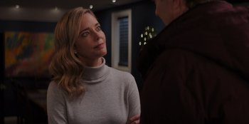 Movie still from “I Believe in Santa” (2022), directed by Alex Ranarivelo – A woman standing next to a man in a room; Close Up shot, Over the shoulder angle