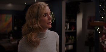 Movie still from “I Believe in Santa” (2022), directed by Alex Ranarivelo – A woman with blonde hair wearing a white sweater; Close Up shot, Over the shoulder angle